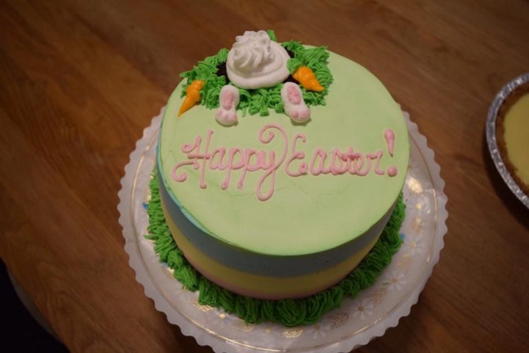 Pastel Easter cake decorated with a bunny, carrots and pink lettering